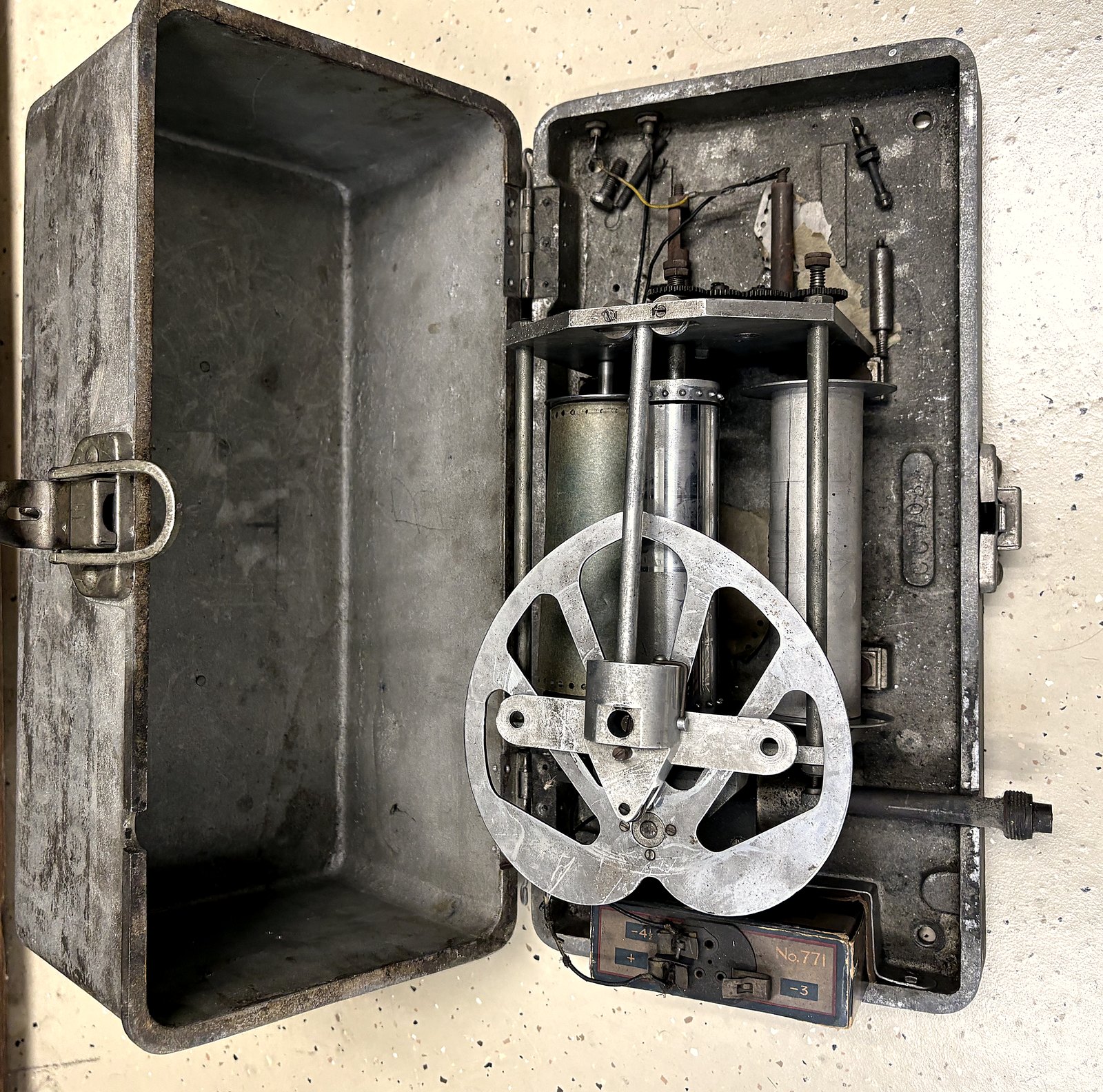 The opened Savage Impact Register showing its internal flywheel, chart drums, and stylus mechanism, unit number 771.