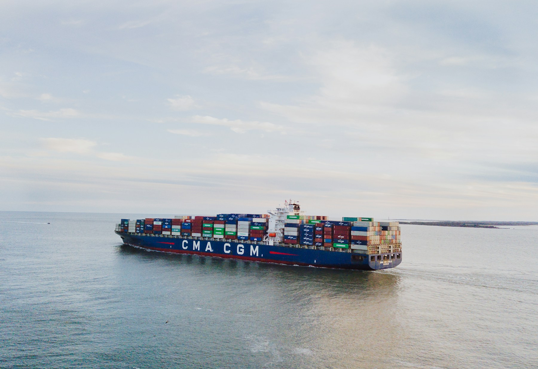 A container ship carrying freight across coastal waters